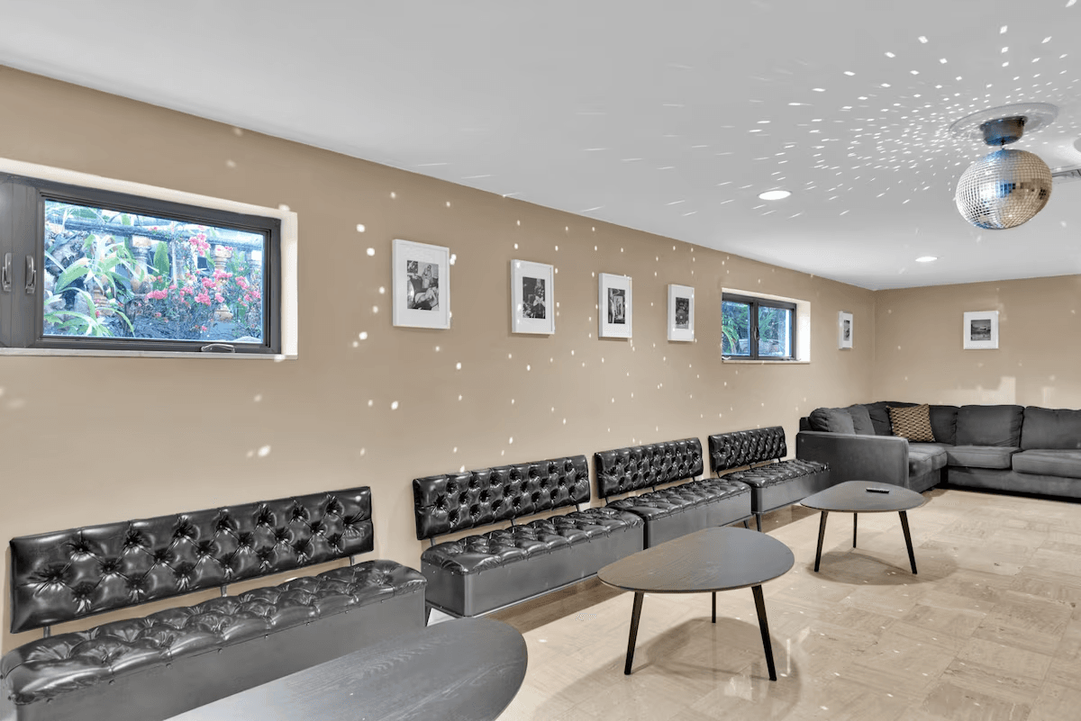 Lounge seating beneath a disco ball in the planned creator house
